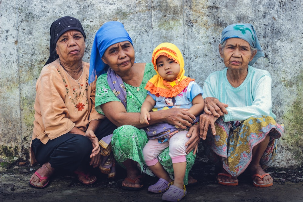 3 women sitting on ground