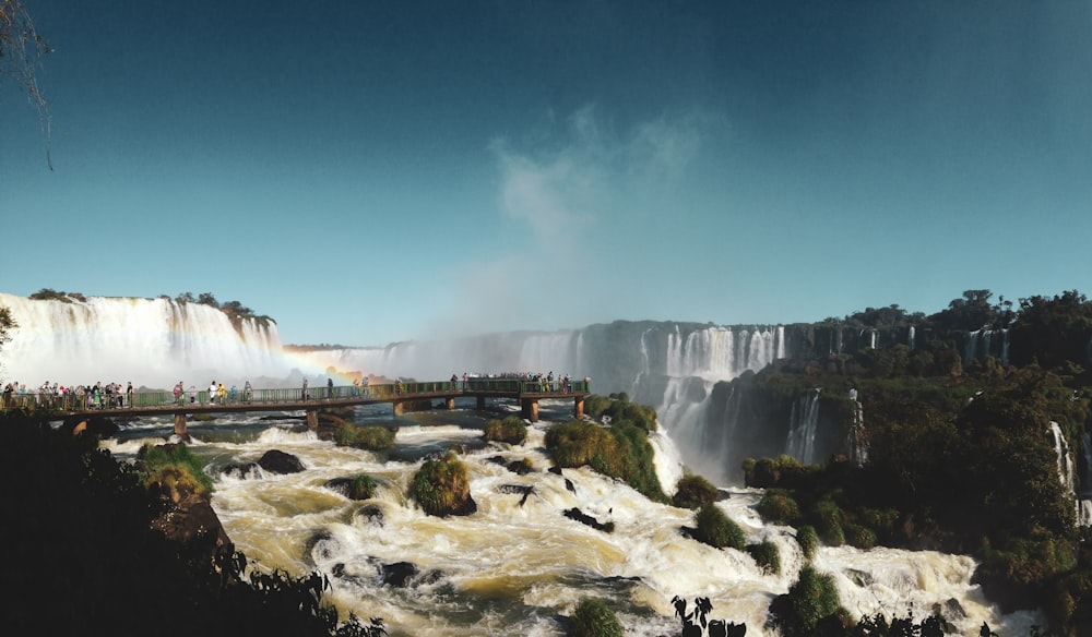 white and brown concrete building near waterfalls under blue sky during daytime