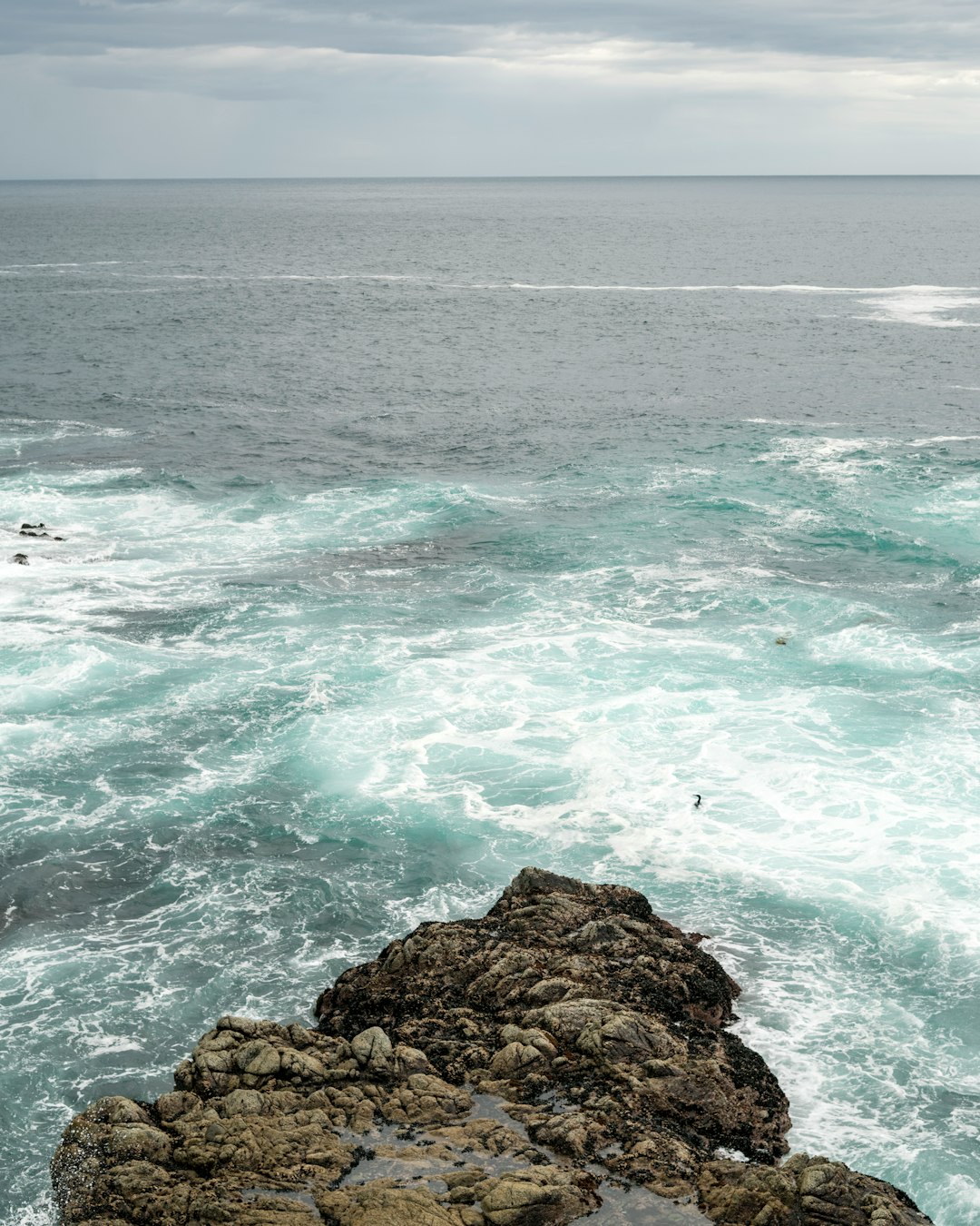 brown rock formation on sea water during daytime