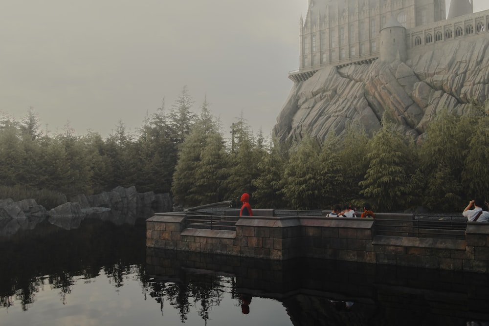 man in red jacket standing on dock during daytime