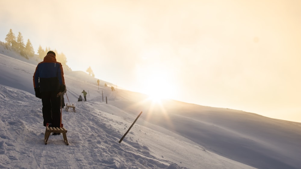 people walking on snow covered mountain during daytime