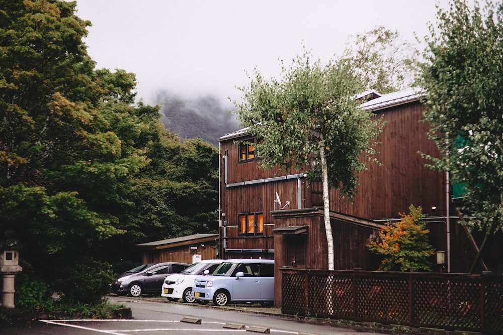 white suv parked beside brown wooden house during daytime