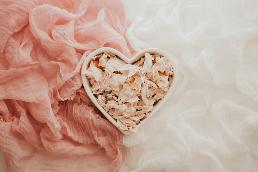 white ceramic bowl on pink textile