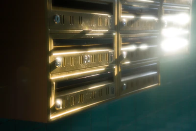 A joyful moment of someone opening their mailbox, sunlight casting warm shadows on the colorful envelopes inside.