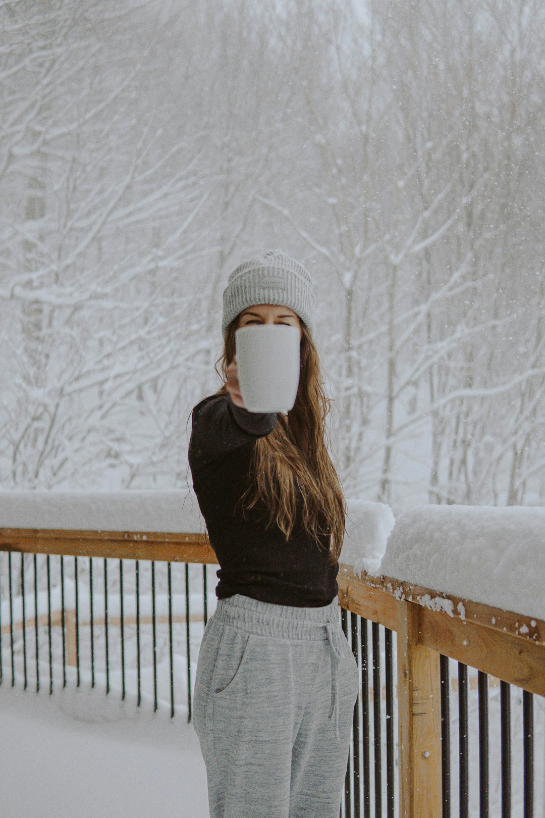 woman in black sweater and gray and white plaid skirt standing on snow covered ground during