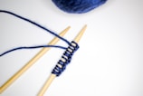 A DIY kit with yarn and knitting needles.