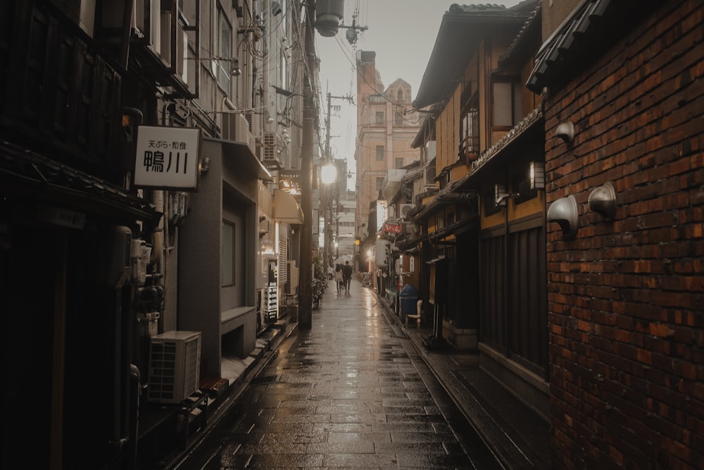 people walking on street between buildings during daytime