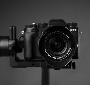 black nikon dslr camera on brown wooden table