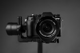 black nikon dslr camera on brown wooden table