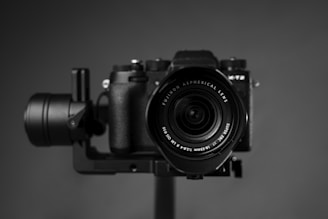 black nikon dslr camera on brown wooden table