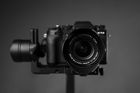 black nikon dslr camera on brown wooden table