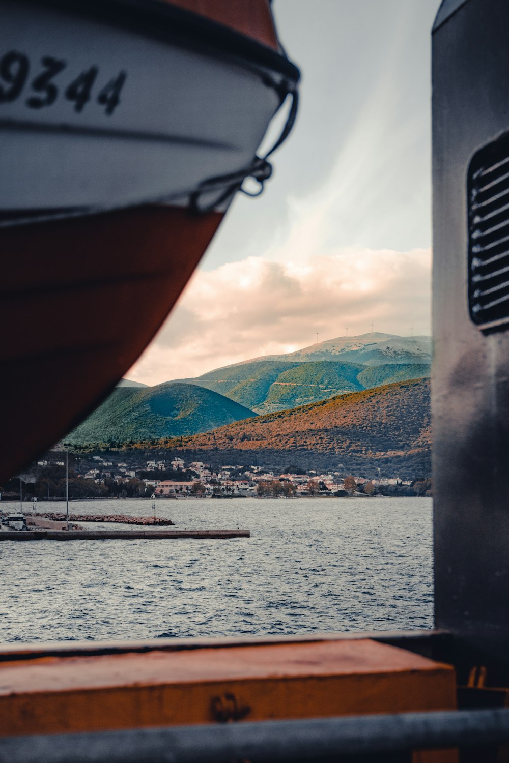 boat on water near mountain during daytime