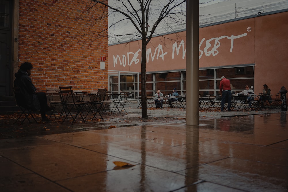 people walking on sidewalk near brown building during daytime