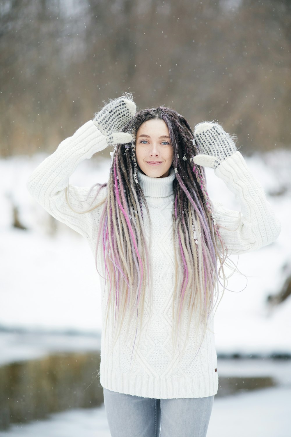 woman in white long sleeve shirt standing on snow covered ground during daytime