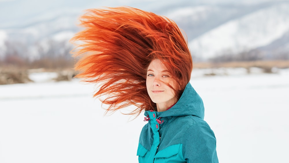 woman in blue hoodie with red hair