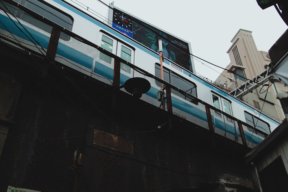 blue and white train on rail during daytime