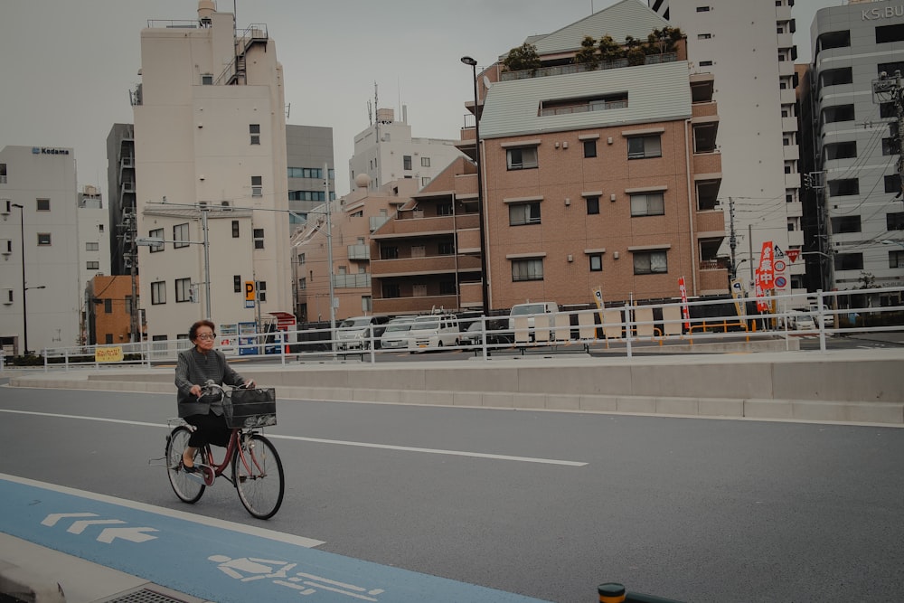 man in black jacket riding bicycle on road during daytime