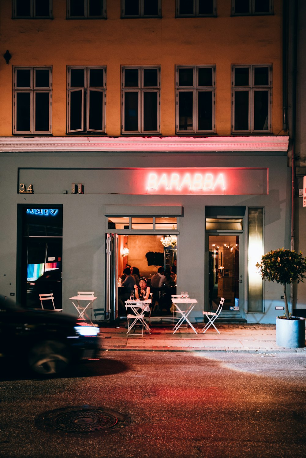 2 women sitting on chair in front of store