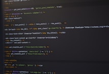 PHP code is displayed on a dark-themed text editor, featuring HTML tags and PHP functions. The code handles the retrieval and display of posts, with conditional statements and template inclusion.
