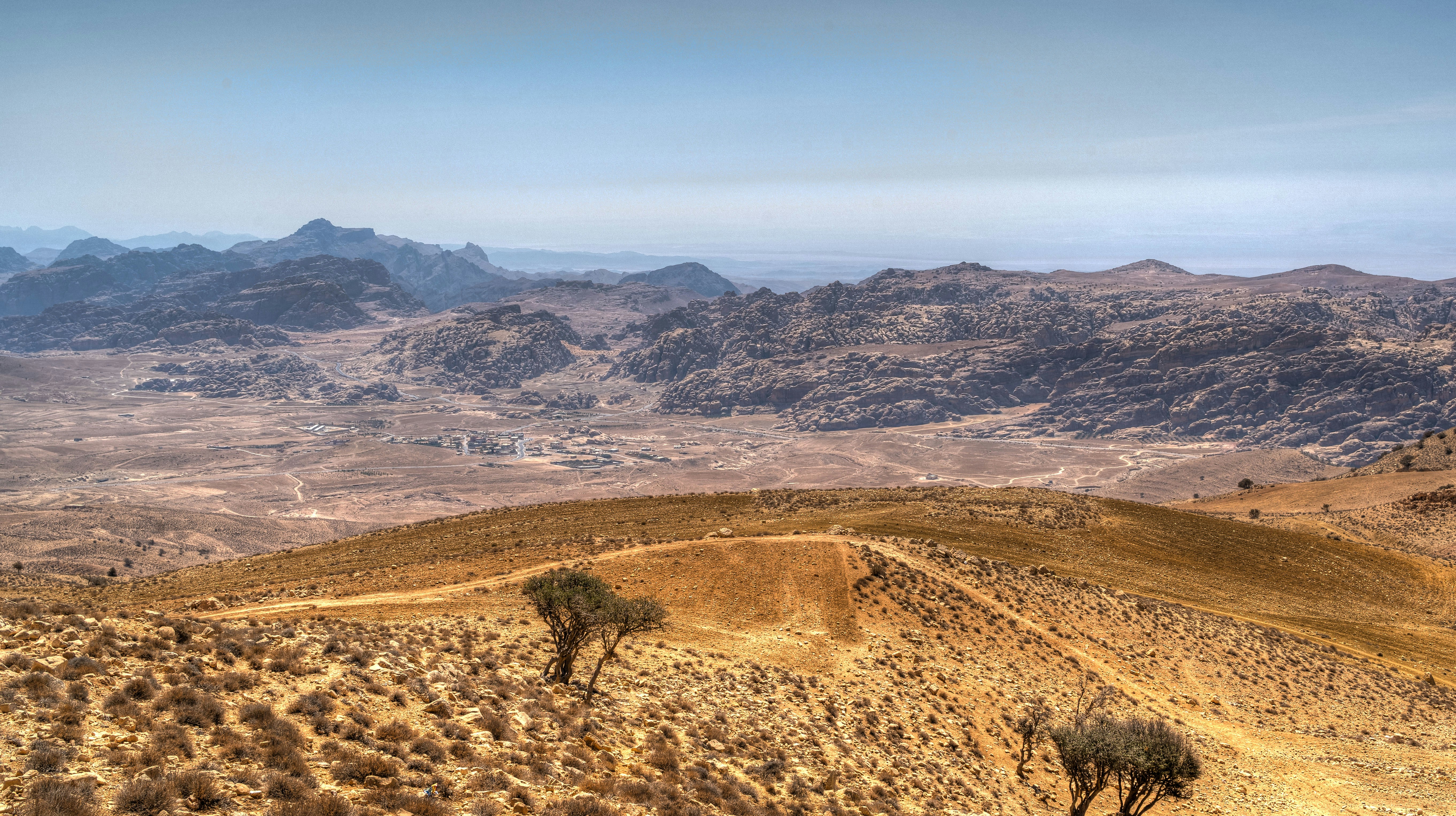 Brown and green mountains under blue sky during daytime