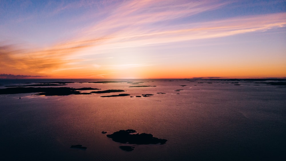 body of water during sunset