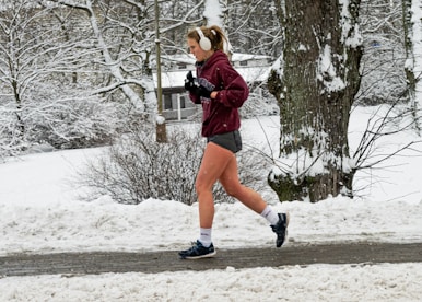 A person listening to a podcast while jogging outdoors.