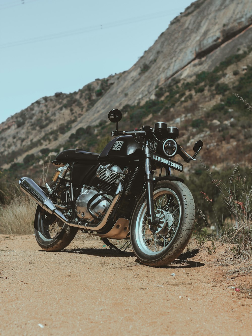 black and gray motorcycle on brown field during daytime