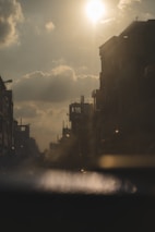 A candid shot of a city street at golden hour, highlighting urban life and shadows.