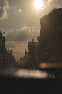 An urban landscape photo capturing the golden hour with warm orange hues.