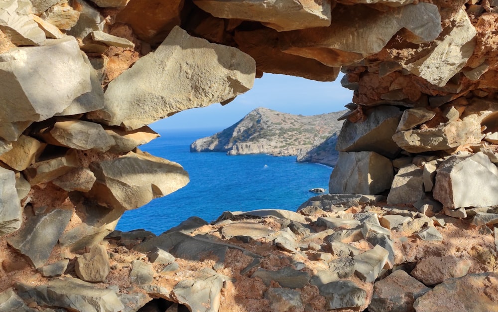 a view of a body of water through rocks