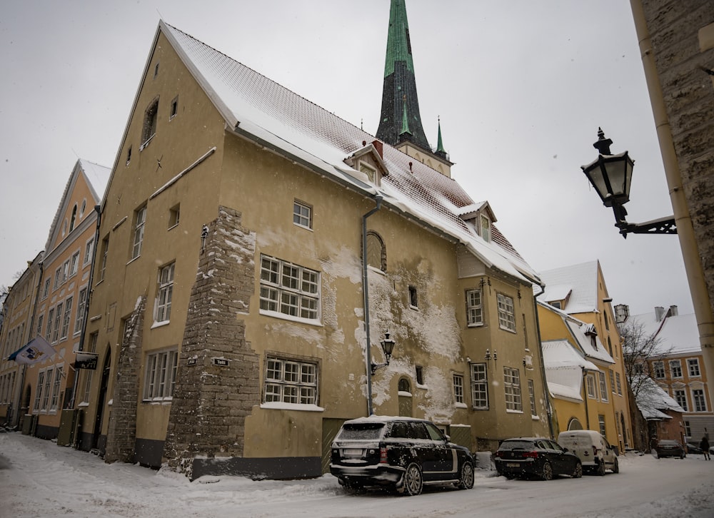 cars parked beside brown concrete building during daytime