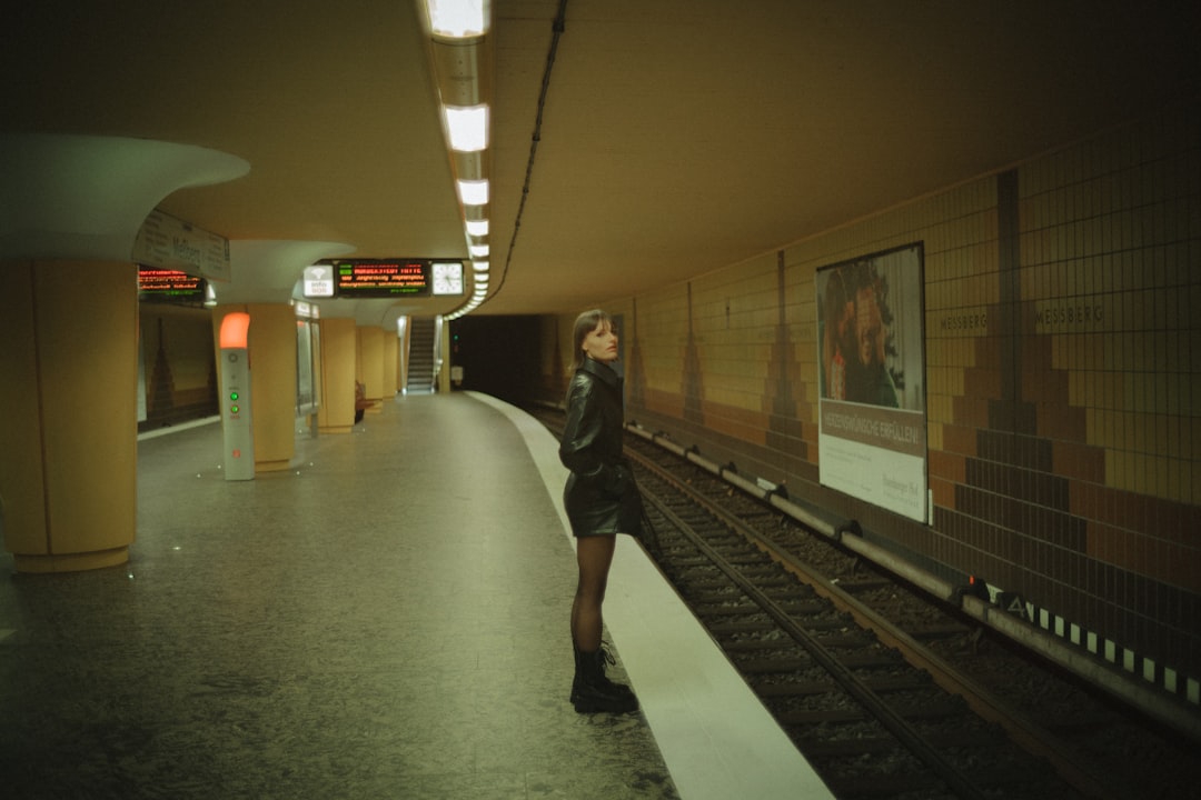 woman in black jacket walking on train station