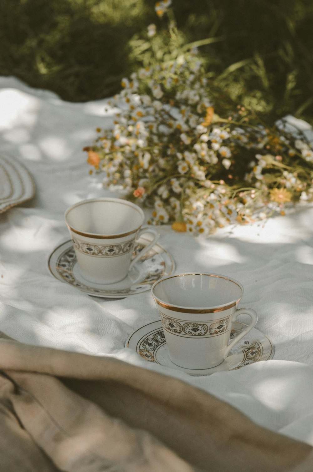 white and blue floral ceramic teacup on saucer