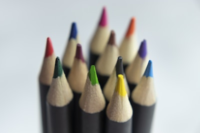 Close-up of vibrant colored pencils standing upright in a cup.