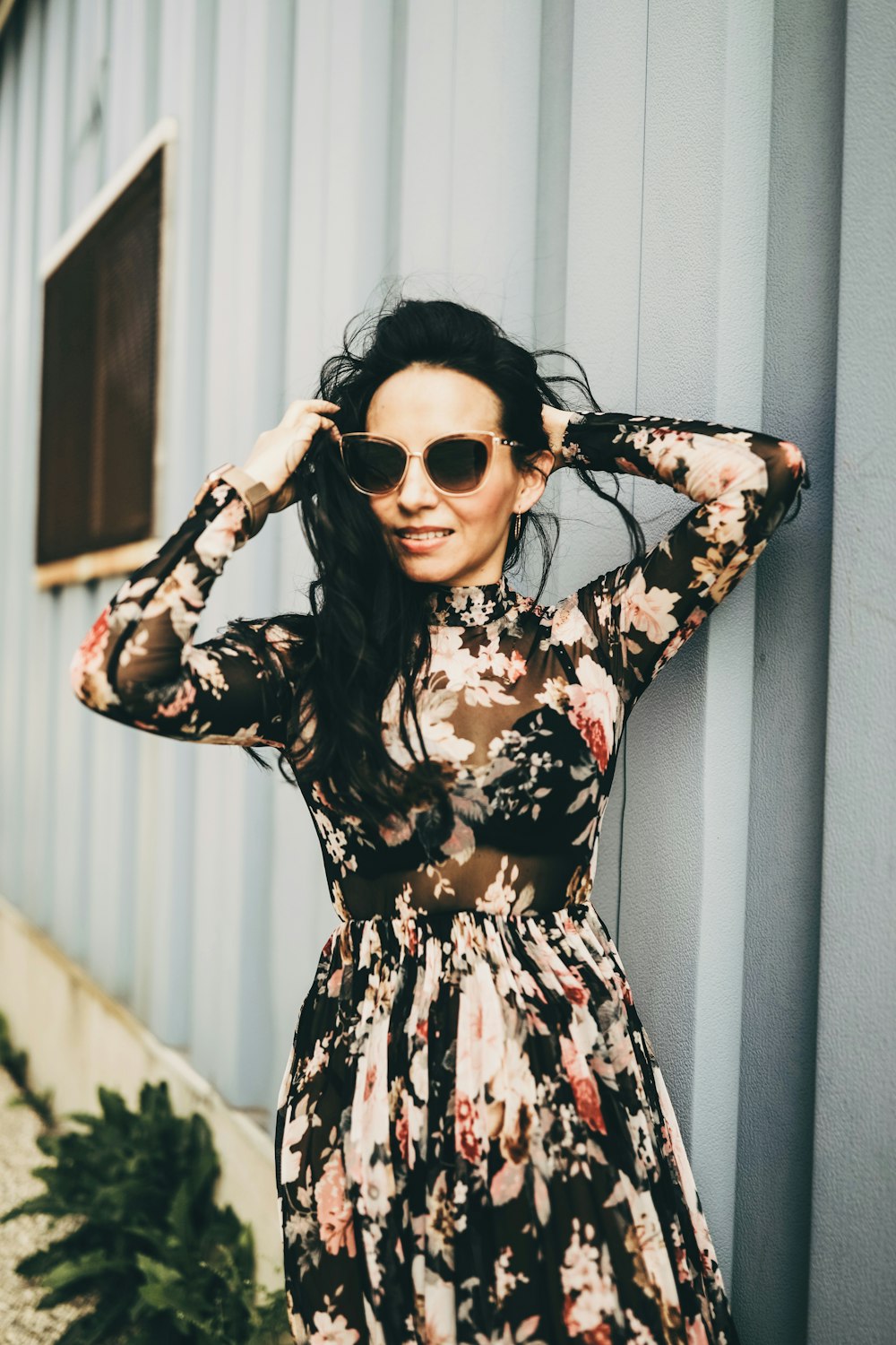 woman in black and red floral long sleeve dress wearing black sunglasses