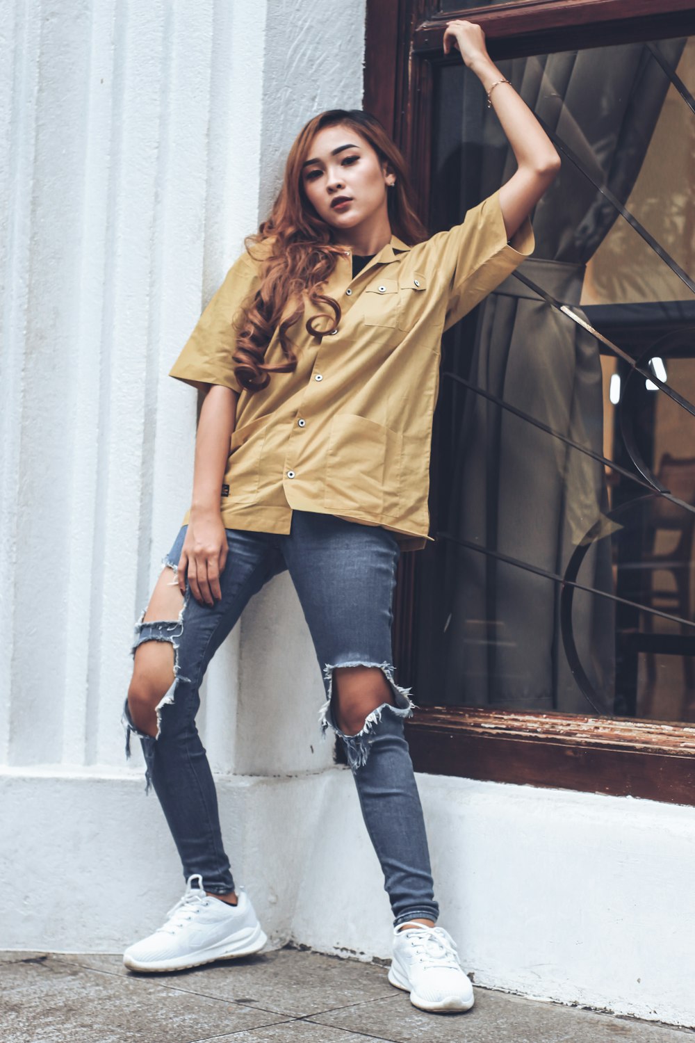 woman in yellow polo shirt and blue denim jeans