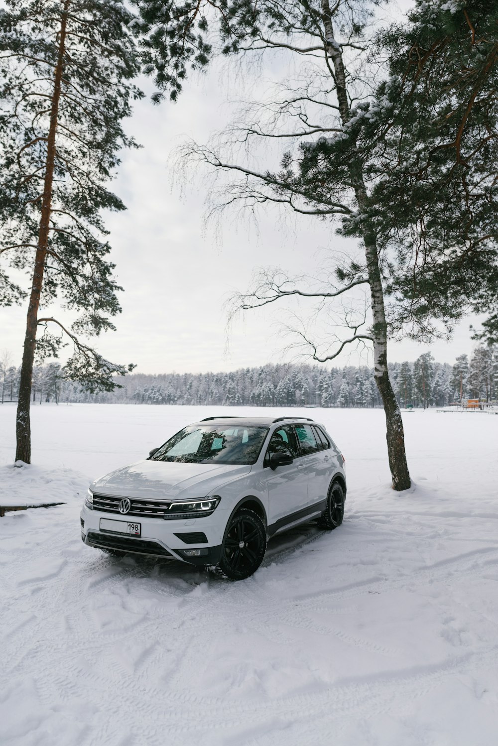 white bmw x series parked on snow covered ground