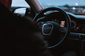 Close-up of a sleek Audi dashboard illuminated at night.