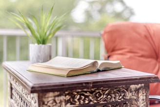 opened book on brown wooden table