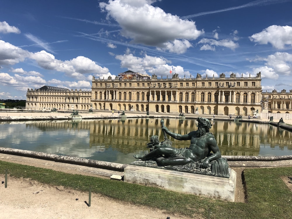 black statue near body of water during daytime