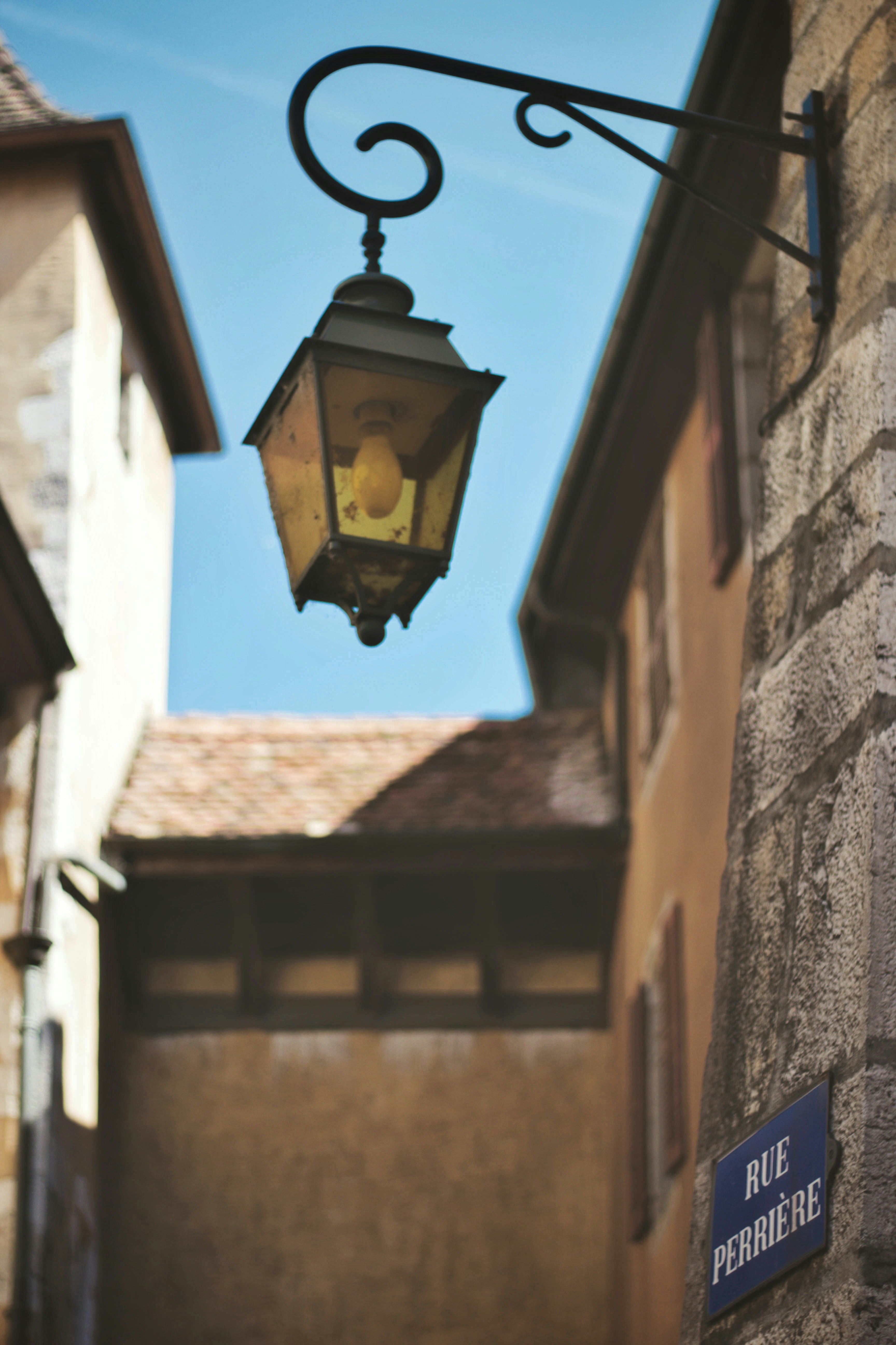 black sconce lamp on brown brick wall during daytime