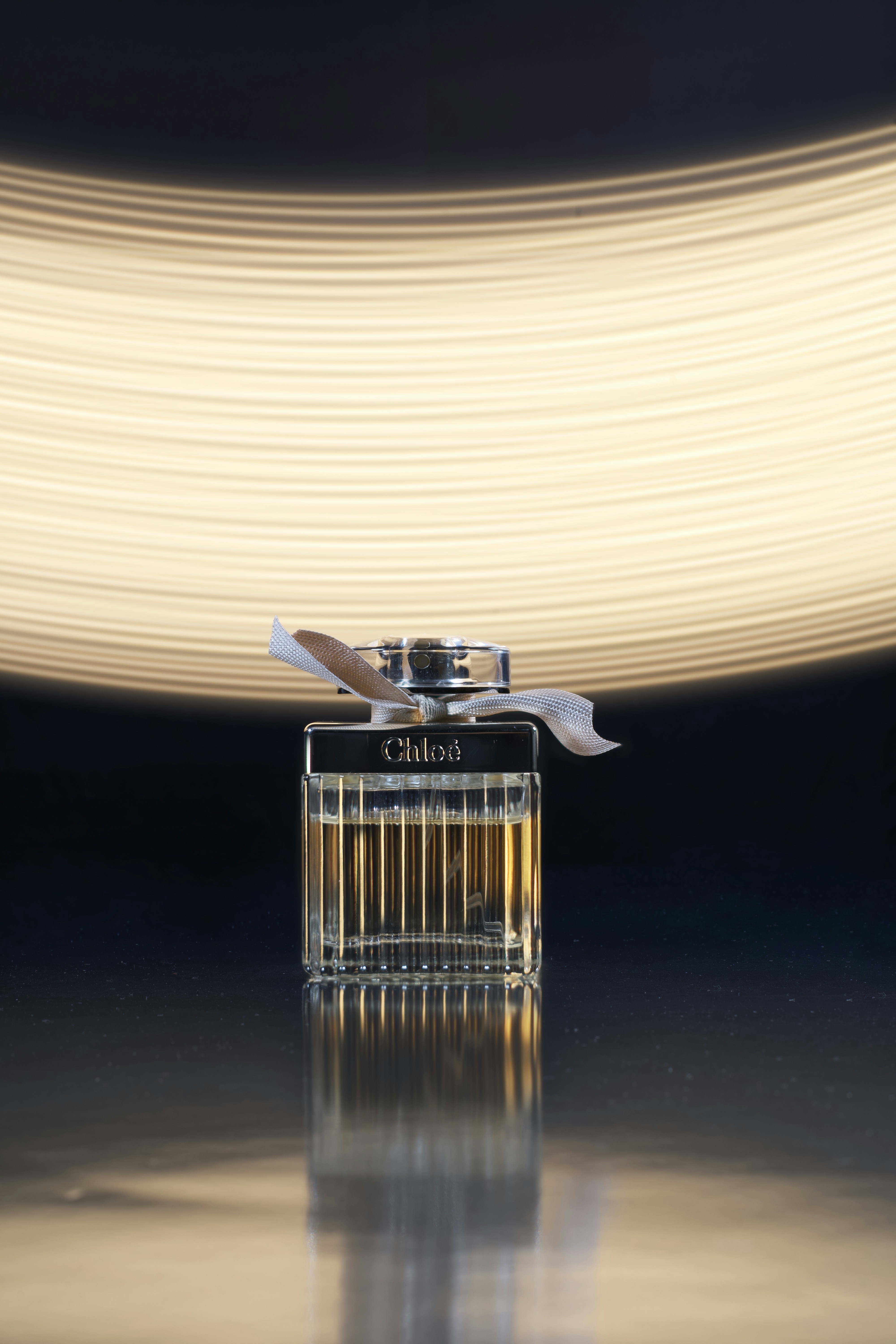 silver and black lighter with white light