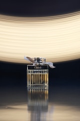 silver and black lighter with white light