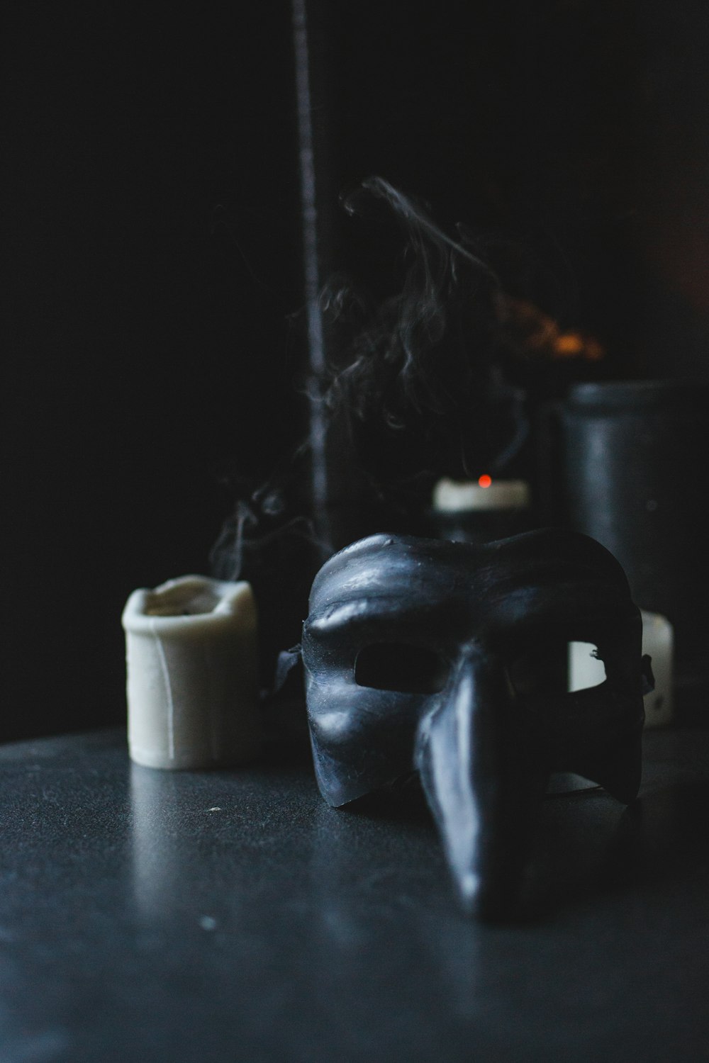 black skull candle holder beside white pillar candle