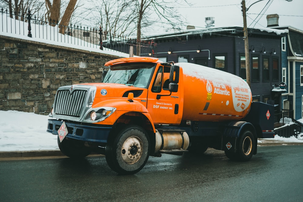 orange and white truck on road during daytime