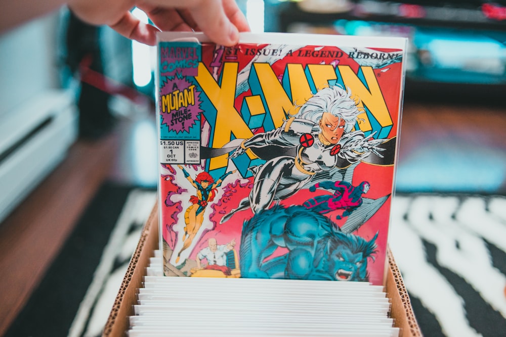 a person holding a comic book in their hand