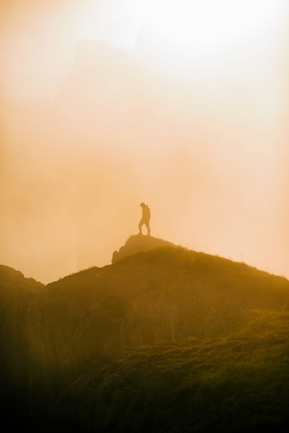 person standing on rock formation during daytime