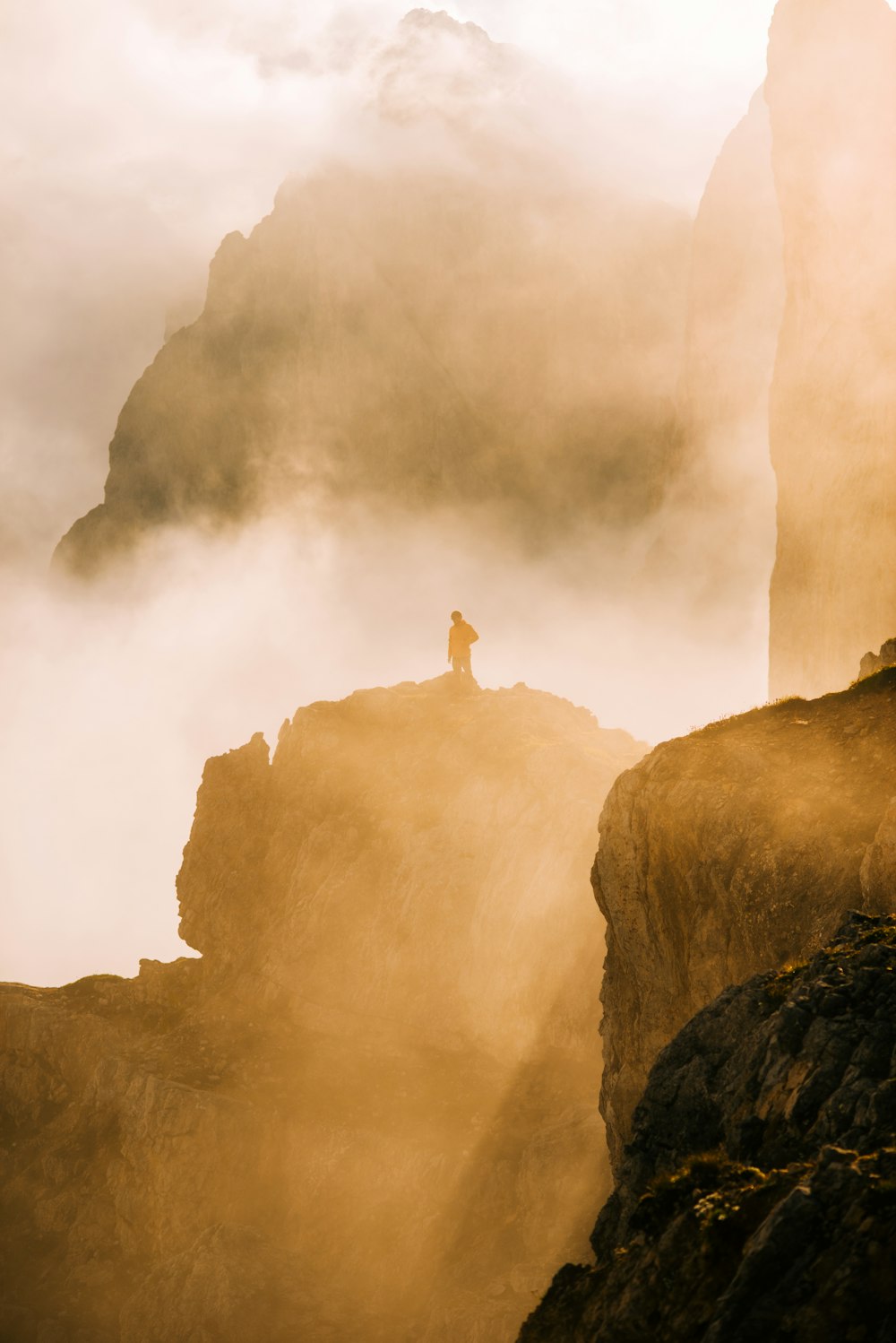 person standing on rock formation during daytime