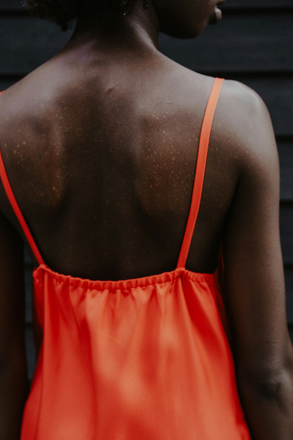 woman in red spaghetti strap top