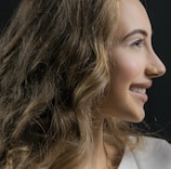 Side profile of a smiling woman comfortably wearing an aurewah clip during her daily routine.